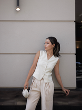 a lady in a beige single-breasted vest with a satin pants